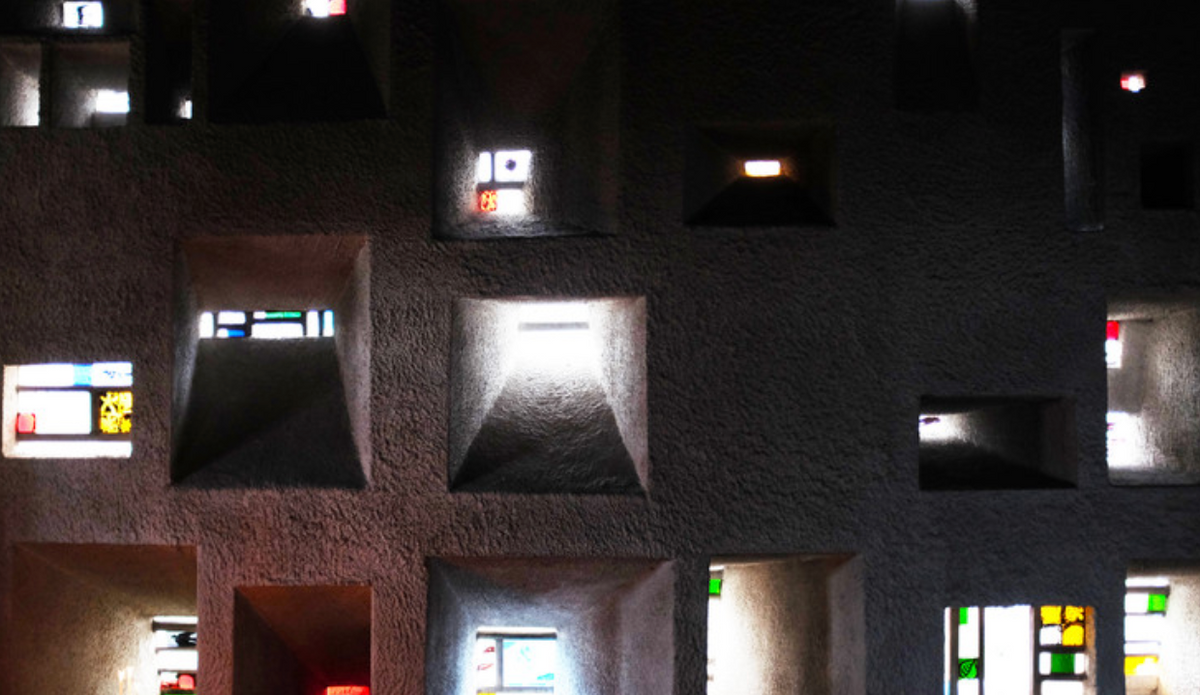 Close-up of textured concrete surface with embedded lights and small windows