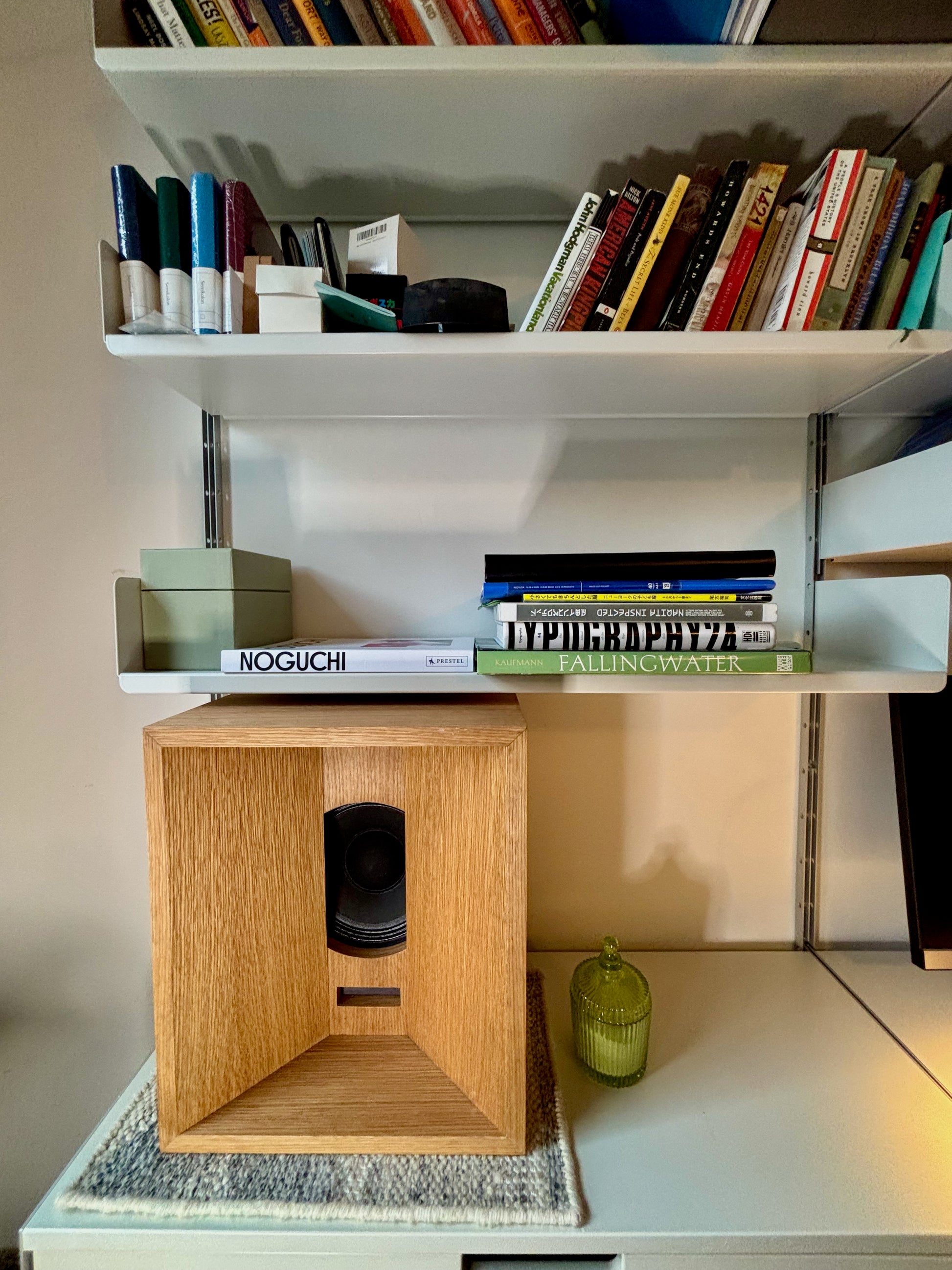 Speaker made in Brooklyn sitting on Vitsoe wall mounted shelf